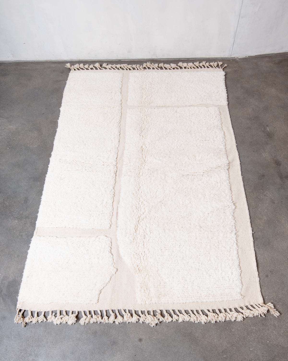 Modern, designer, handcrafted Berber rug from Morocco. Beniourain carpet with minimalist design, natural wool pile and a fluffy texture.